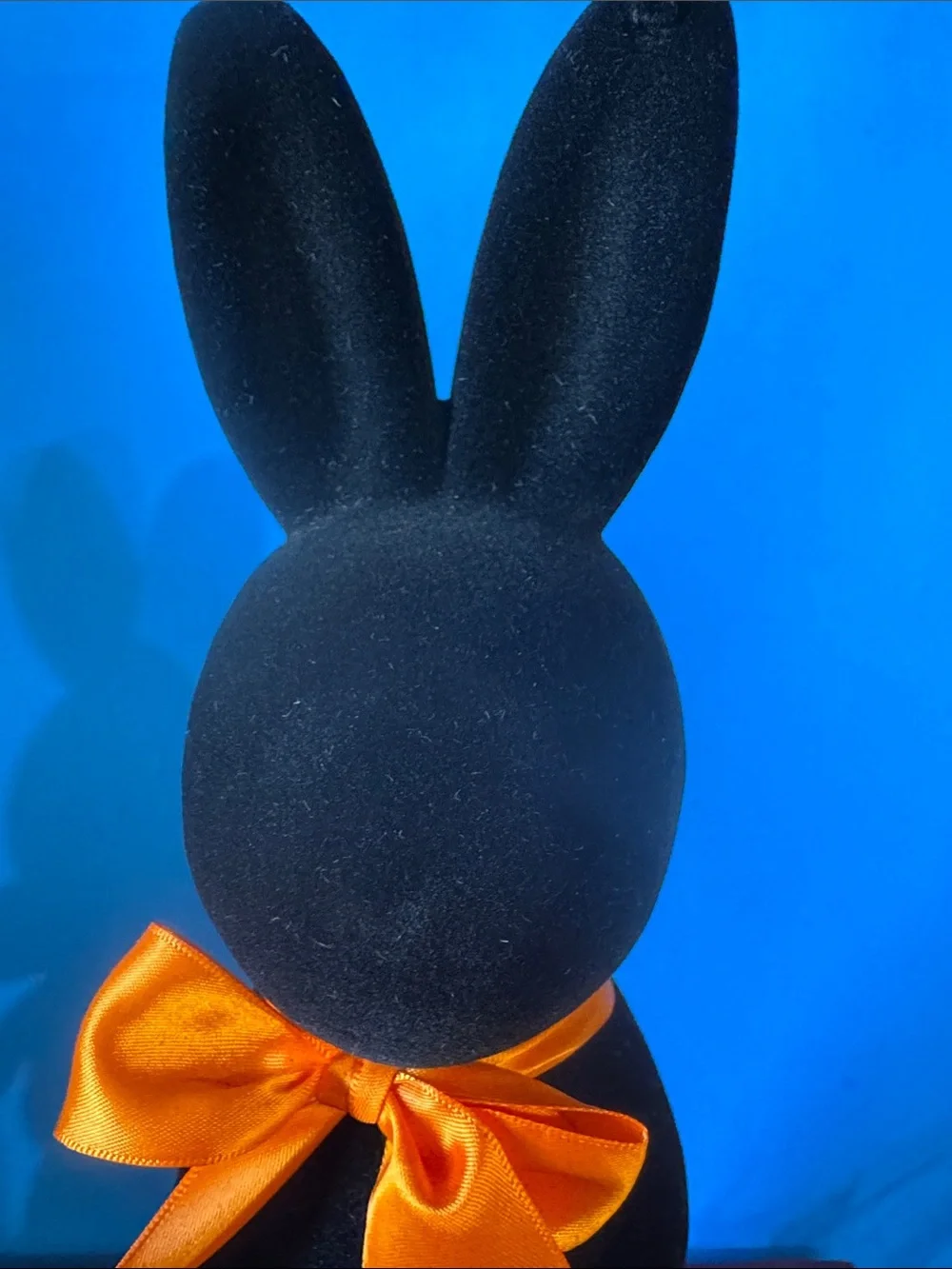 Black flocked (fuzzy) bunny figurine w/orange bow contemporary Easter- NEW